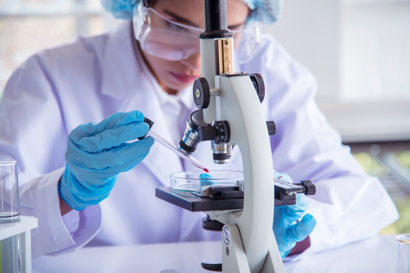 Laboratory staff processing samples at a workbench